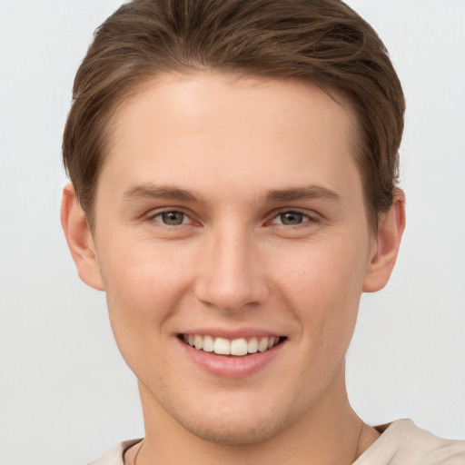 Joyful white young-adult female with short  brown hair and grey eyes