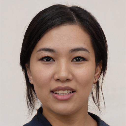 Joyful asian young-adult female with medium  black hair and brown eyes