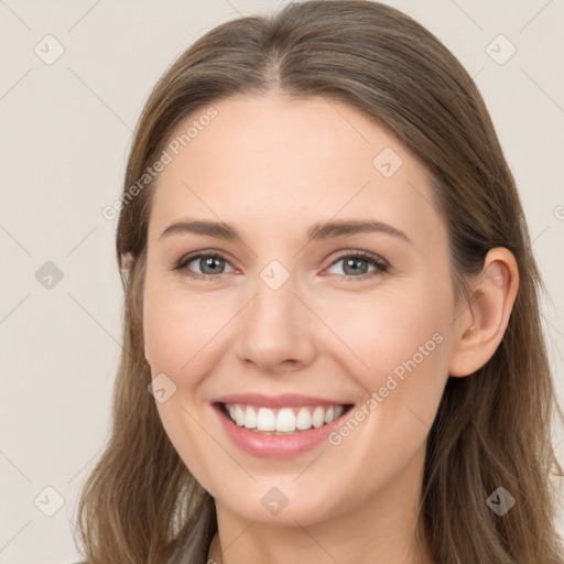 Joyful white young-adult female with long  brown hair and grey eyes