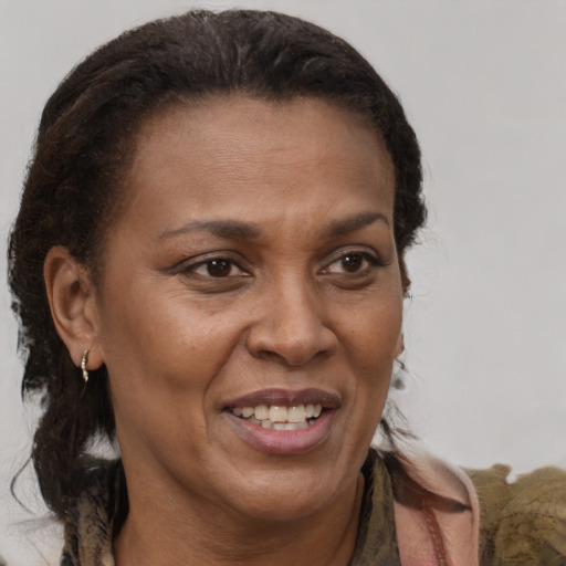 Joyful black adult female with medium  brown hair and brown eyes