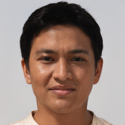 Joyful asian young-adult male with short  black hair and brown eyes