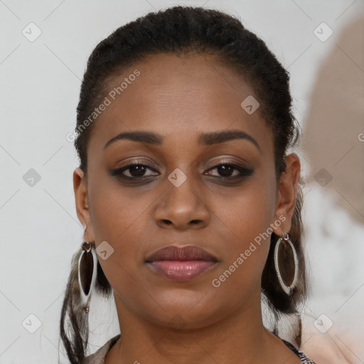 Joyful black young-adult female with long  brown hair and brown eyes