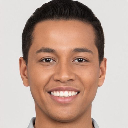 Joyful latino young-adult male with short  brown hair and brown eyes