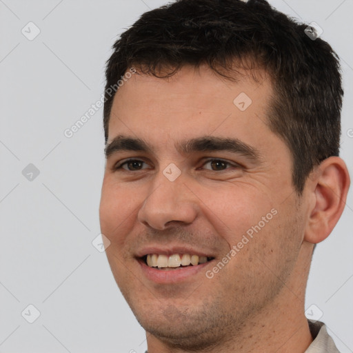 Joyful white young-adult male with short  brown hair and brown eyes