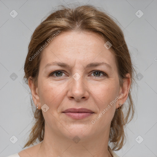 Joyful white adult female with medium  brown hair and grey eyes