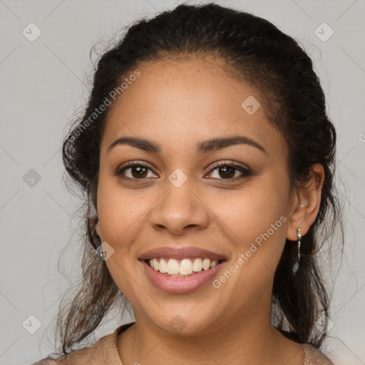 Joyful latino young-adult female with long  brown hair and brown eyes