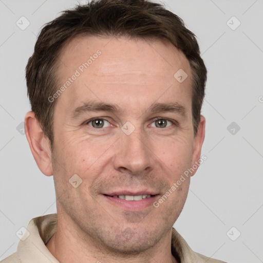 Joyful white adult male with short  brown hair and grey eyes