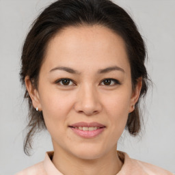 Joyful asian young-adult female with medium  brown hair and brown eyes