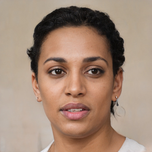 Joyful latino young-adult female with short  black hair and brown eyes