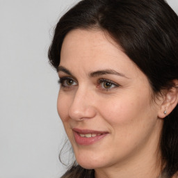 Joyful white adult female with medium  brown hair and brown eyes