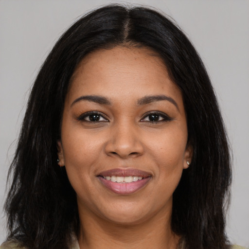 Joyful latino young-adult female with long  brown hair and brown eyes