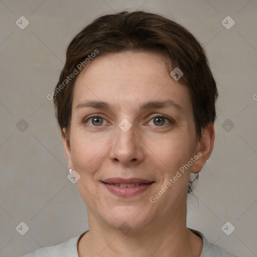 Joyful white adult female with short  brown hair and grey eyes