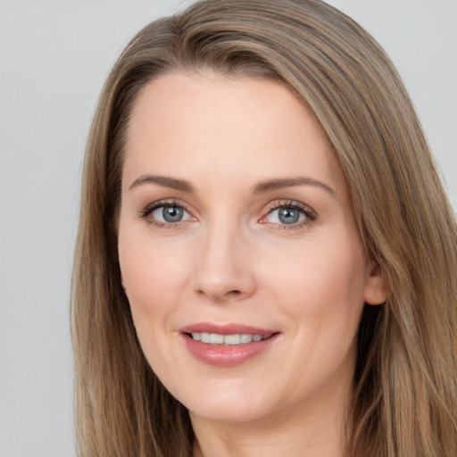 Joyful white young-adult female with long  brown hair and grey eyes