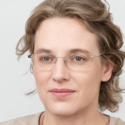 Joyful white adult female with medium  brown hair and blue eyes