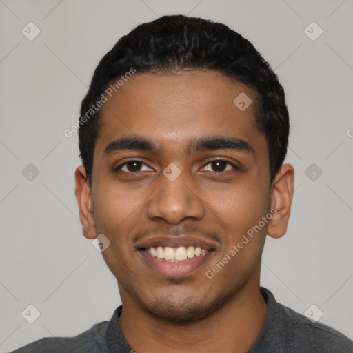 Joyful black young-adult male with short  black hair and brown eyes