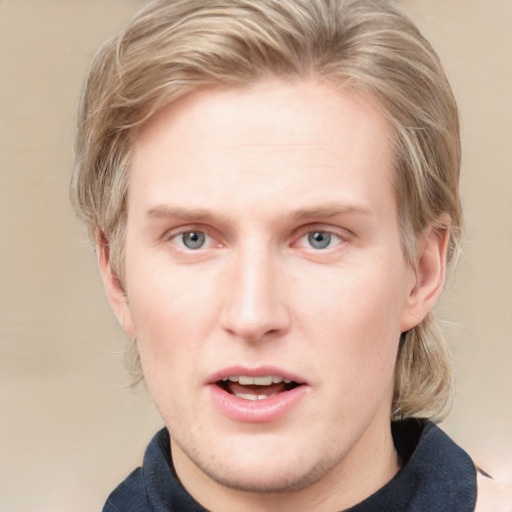 Joyful white young-adult male with medium  brown hair and grey eyes