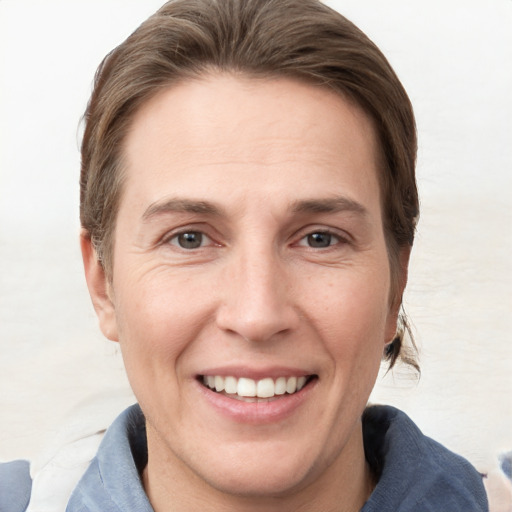 Joyful white adult female with short  brown hair and grey eyes