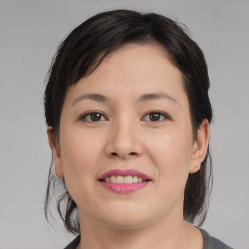 Joyful asian young-adult female with medium  brown hair and brown eyes