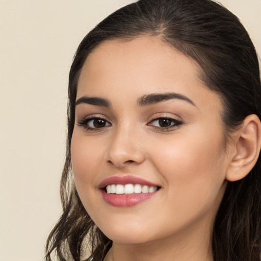 Joyful white young-adult female with long  brown hair and brown eyes