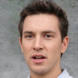 Joyful white adult male with short  brown hair and grey eyes