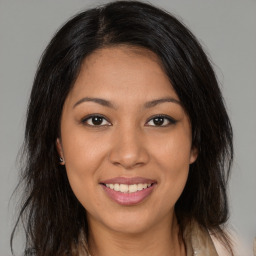 Joyful latino young-adult female with medium  brown hair and brown eyes