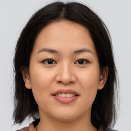 Joyful asian young-adult female with medium  brown hair and brown eyes