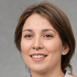 Joyful white adult female with medium  brown hair and brown eyes