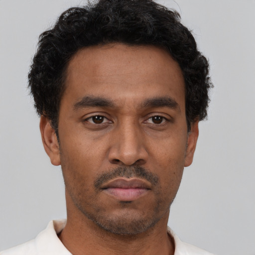 Neutral latino young-adult male with short  brown hair and brown eyes