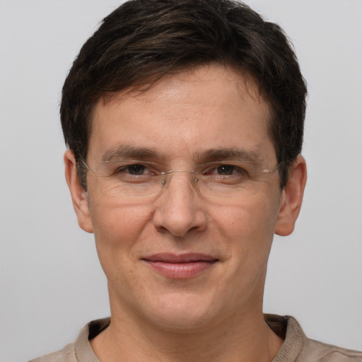 Joyful white adult male with short  brown hair and brown eyes