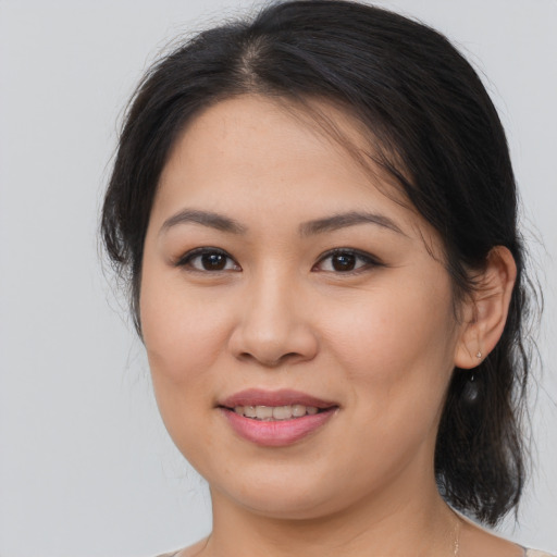 Joyful asian young-adult female with medium  brown hair and brown eyes