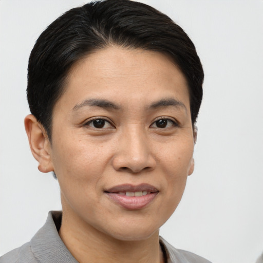 Joyful asian young-adult female with short  brown hair and brown eyes
