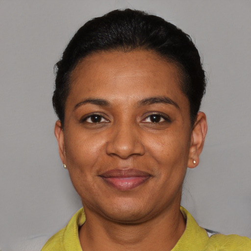 Joyful black adult female with short  black hair and brown eyes