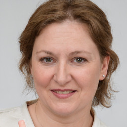 Joyful white adult female with medium  brown hair and grey eyes