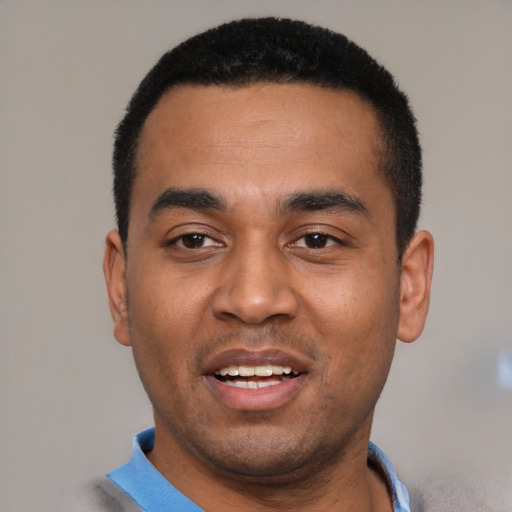 Joyful black young-adult male with short  black hair and brown eyes