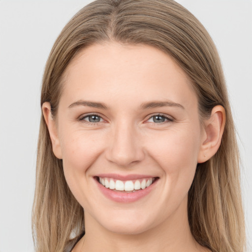 Joyful white young-adult female with long  brown hair and grey eyes