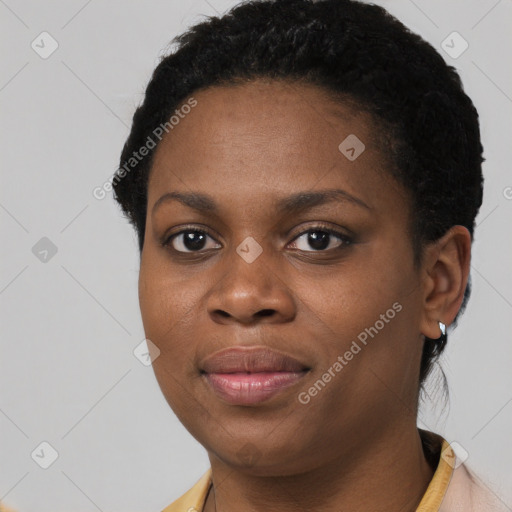 Joyful black young-adult female with short  black hair and brown eyes