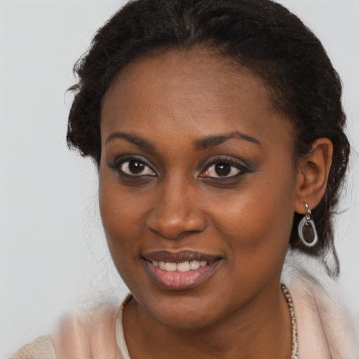 Joyful black young-adult female with long  brown hair and brown eyes