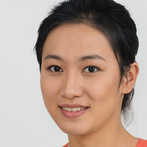 Joyful latino young-adult female with medium  black hair and brown eyes