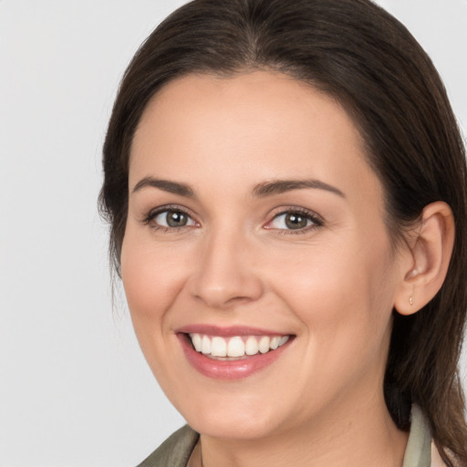 Joyful white young-adult female with medium  brown hair and brown eyes