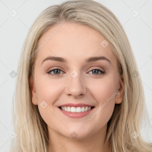 Joyful white young-adult female with long  brown hair and blue eyes