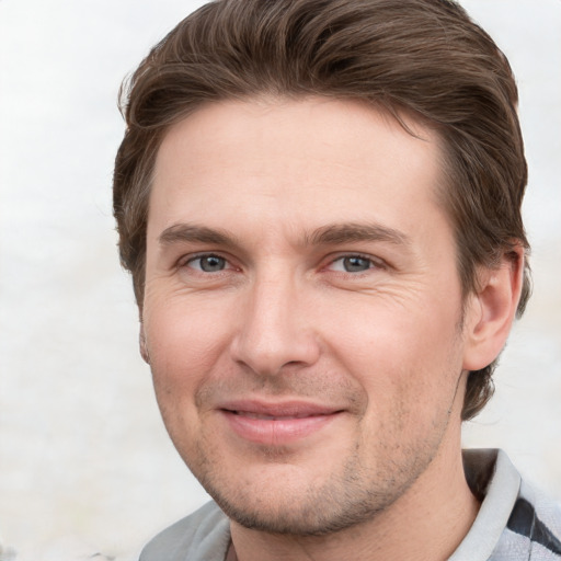 Joyful white young-adult male with short  brown hair and grey eyes