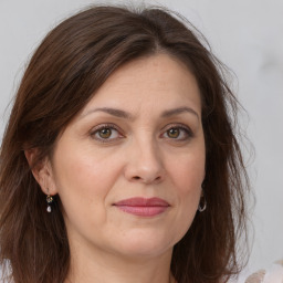 Joyful white adult female with long  brown hair and brown eyes