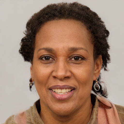 Joyful black adult female with short  brown hair and brown eyes