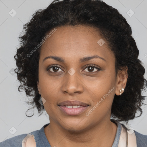 Joyful black young-adult female with long  brown hair and brown eyes