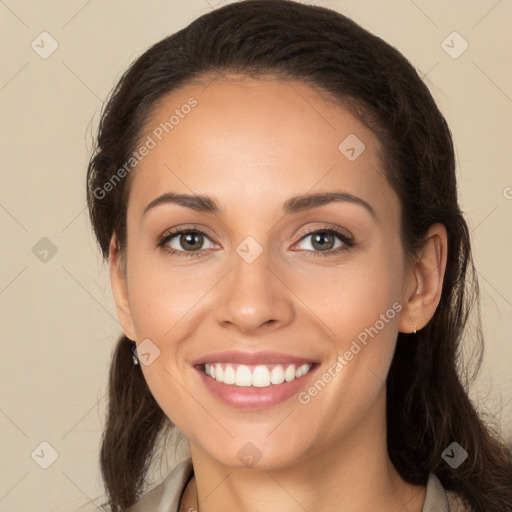 Joyful white young-adult female with long  brown hair and brown eyes