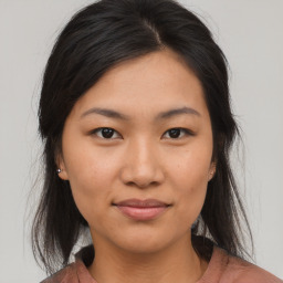 Joyful asian young-adult female with medium  brown hair and brown eyes