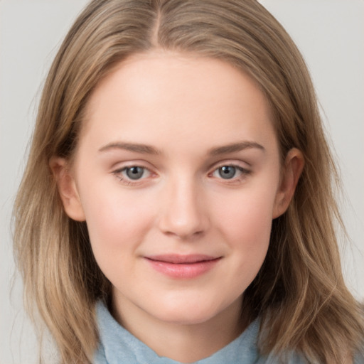 Joyful white child female with medium  brown hair and grey eyes