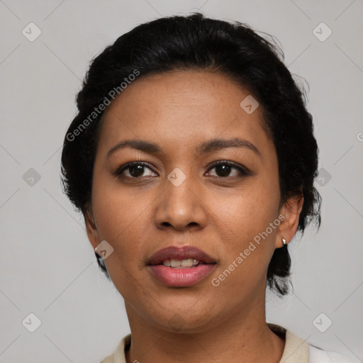 Joyful black adult female with short  black hair and brown eyes