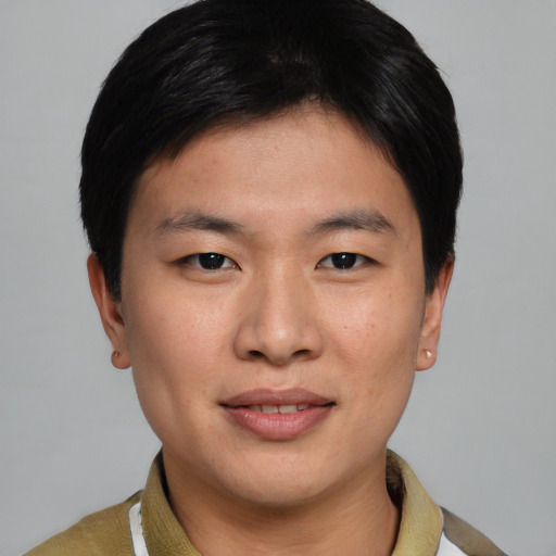 Joyful asian young-adult male with short  brown hair and brown eyes