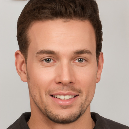 Joyful white young-adult male with short  brown hair and brown eyes